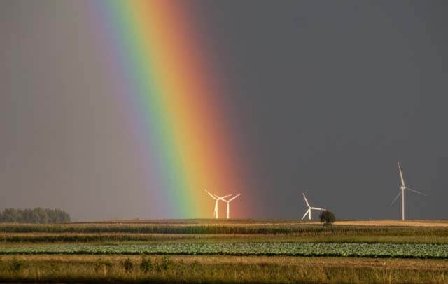 landscape-photography-of-field-with-wind-mill with rainbow
