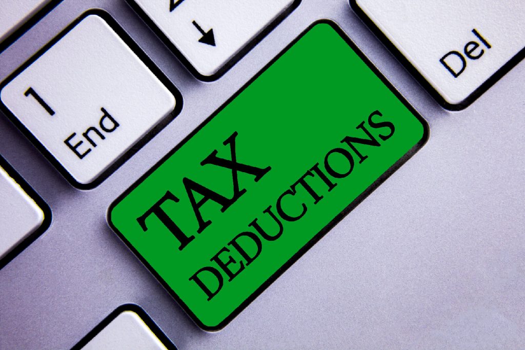 Tax deduction 1 Close up of a man applying adhesive tape on a packing box